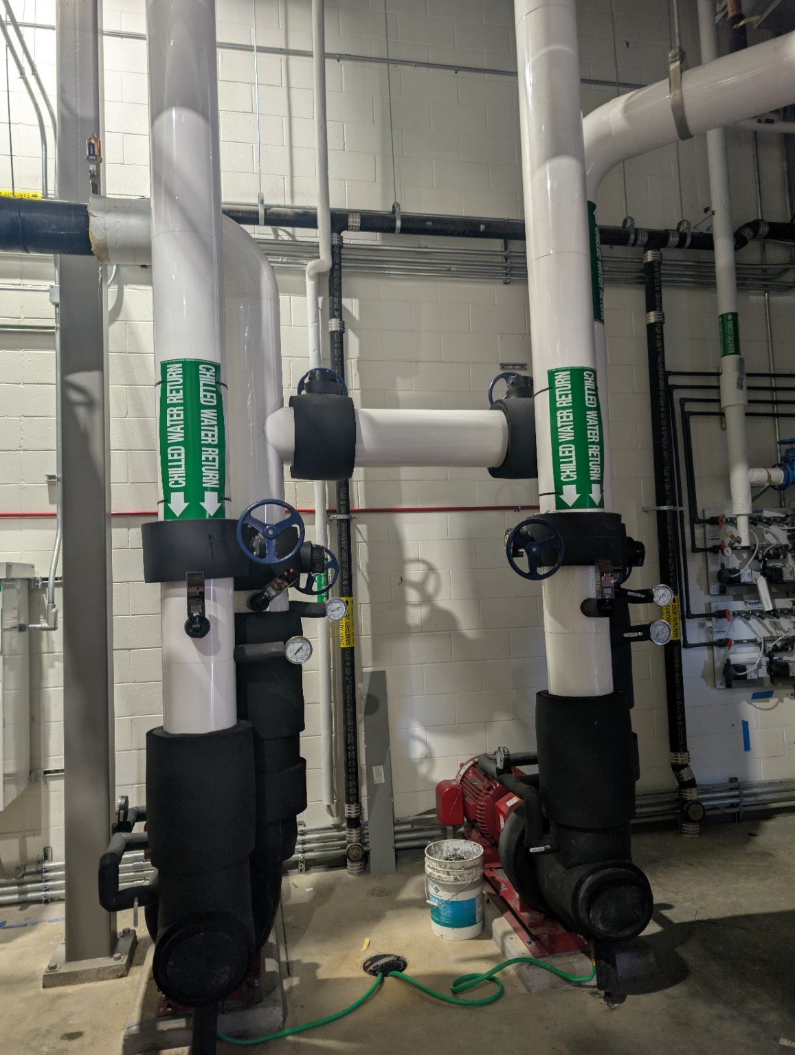 Paired insulated vertical pipe assemblies